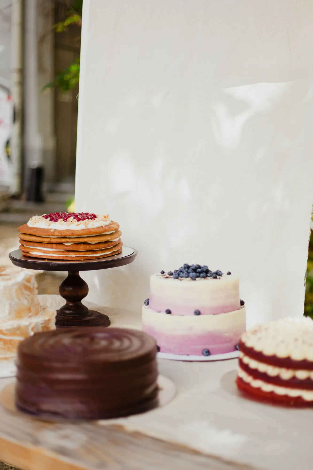 Cream-finished layer cakes arranged against a soft white backdrop